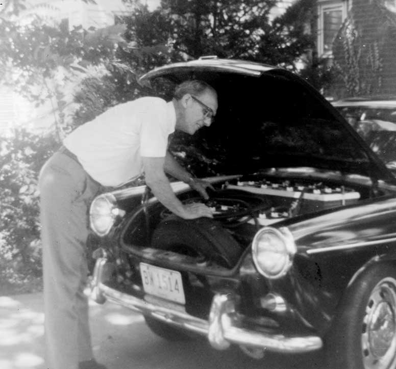 Grandpa Under the Hood of His Electric Car